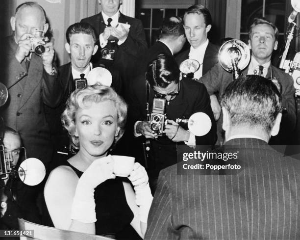 American actress Marilyn Monroe at a press conference at the Savoy Hotel, London, July 1956. Monroe is in England to film 'The Prince and the...