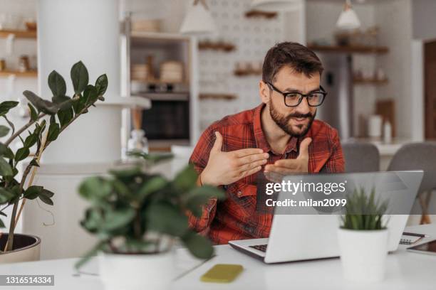 young man working from home - phone interview event stock pictures, royalty-free photos & images