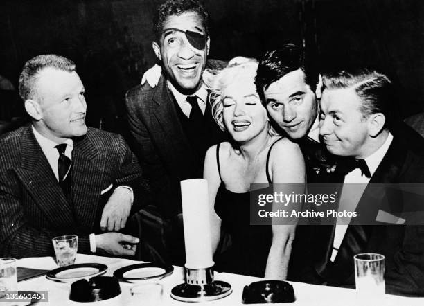 Actor Jacques Sernas, Sammy Davis, Jr Marilyn Monroe , photographer Milton H Greene and jazz musician Mel Torme at the Crescendo Club, Los Angeles,...