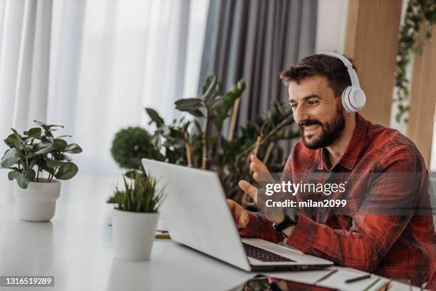young man working from home - laptop sleeve stock pictures, royalty-free photos & images
