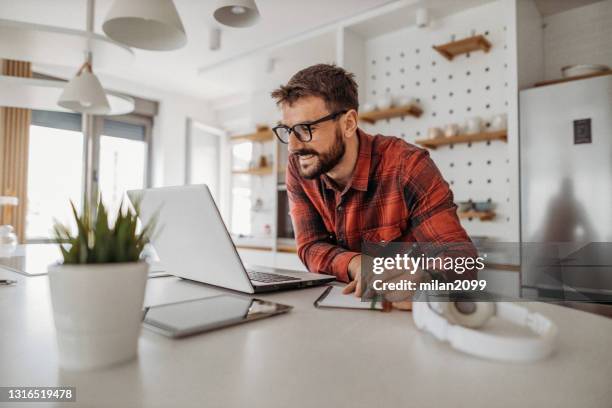 young man working from home - laptop sleeve stock pictures, royalty-free photos & images