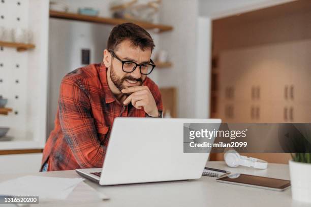 young man working from home - one mid adult man only bildbanksfoton och bilder