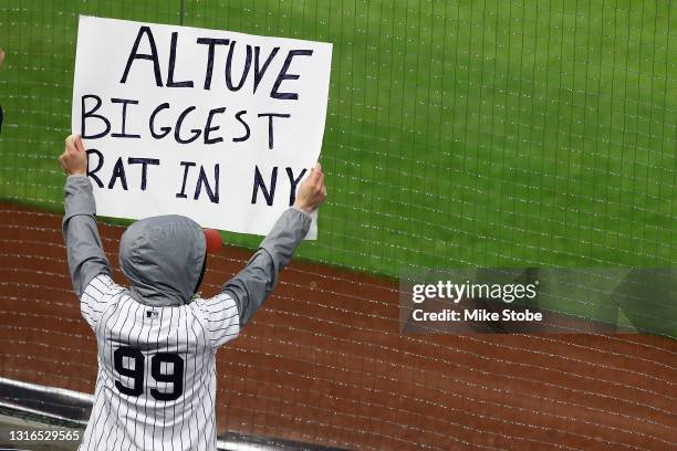 Fans hold signs during the game between the New York Yankees and the Houston Astros at Yankee Stadium on May 05, 2021 in New York City.