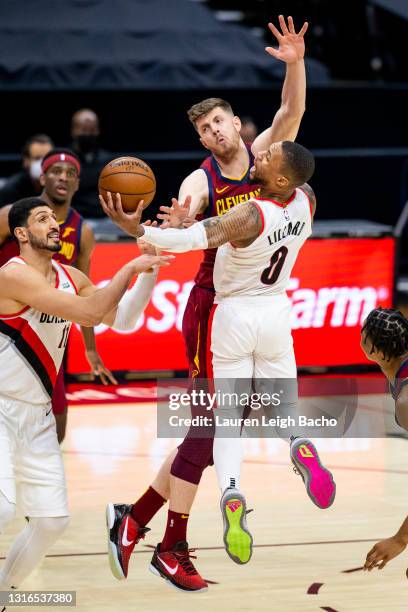Isaiah Hartenstein of the Cleveland Cavaliers fouls Damian Lillard of the Portland Trail Blazers during the third quarter at Rocket Mortgage...