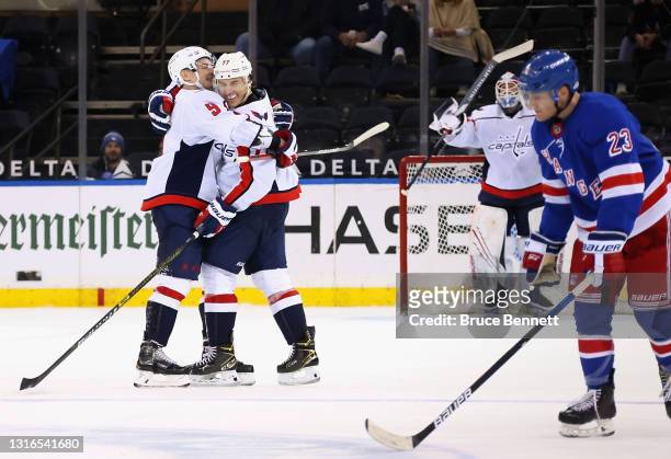Oshie of the Washington Capitals celebrates his hattrick goal at 18:20 of the third period against the New York Rangers as he is hugged by Dmitry...