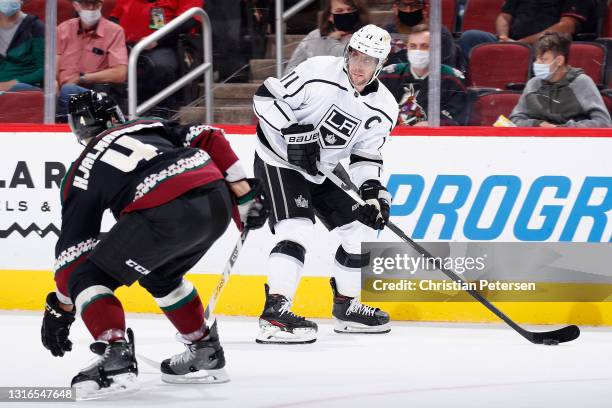 Anze Kopitar of the Los Angeles Kings skates with the puck against Niklas Hjalmarsson of the Arizona Coyotes during the first period of the NHL game...