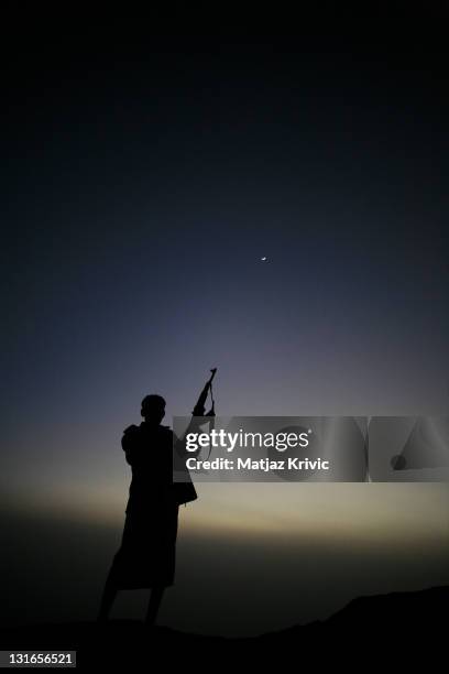 An an armed man guards the Khat fields at dawn in the valley near the village of Jebel Shugruf in the Haraz Mountains on January 3, 2006 in Shugruf,...