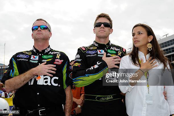 Carl Edwards , driver of the Aflac Ford, stands with his wife Kate and crew chief Bob Osborne on the grid prior to the NASCAR Sprint Cup Series AAA...
