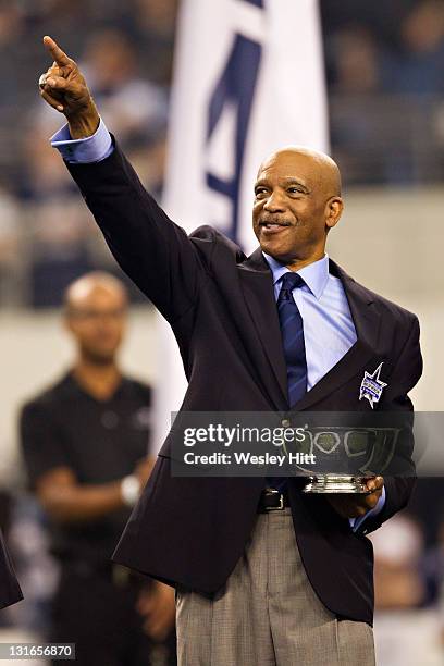 Drew Pearson of the Dallas Cowboys points to his name after being inducted into the Ring of Honor at halftime during a game against the Seattle...