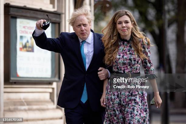 Prime Minister Boris Johnson and his fiancée Carrie Symonds arrive at Methodist Central Hall in Westminster to vote on May 06, 2021 in London,...