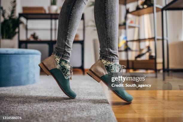 woman trying on shoes in fashion store - leather boot stock pictures, royalty-free photos & images