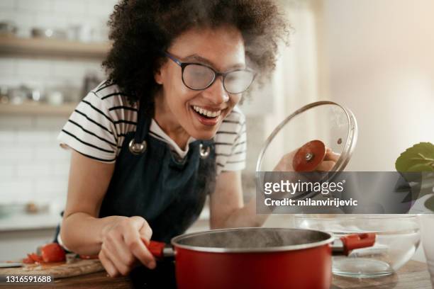 beautiful woman cooking at home. - soup stock pictures, royalty-free photos & images