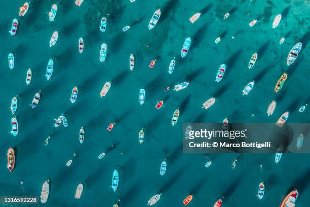 moored boats in turquoise water bay, tenerife, spain - group sea stockfoto's en -beelden