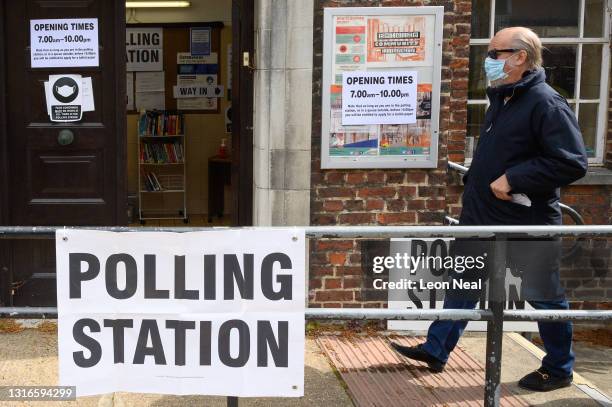 Man wearing a protective face mask enters a polling station on May 06, 2021 in London, United Kingdom. Local elections are being held across England...