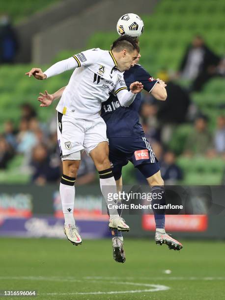 Benat Etxebarria of Macarthur FC and Robbie Kruse of the Victory compete for the ball during the A-League match between Melbourne Victory and...