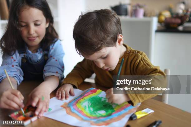 a brother and a sister painting at home - brother sister stock pictures, royalty-free photos & images