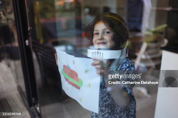 a little girl posing with a flying saucer drawing - house science stock pictures, royalty-free photos & images