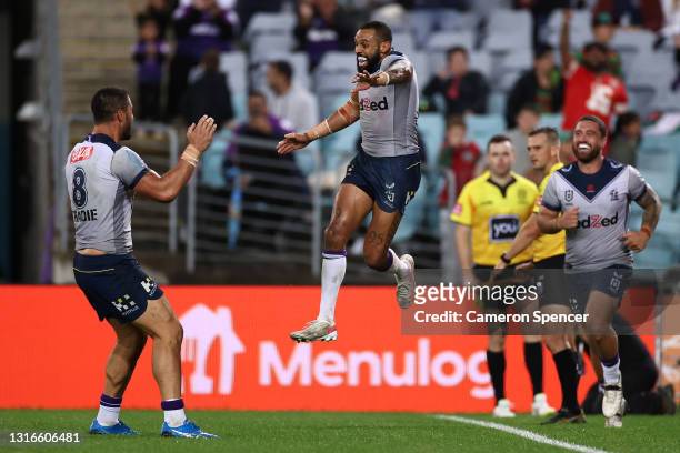 Josh Addo-Carr of the Storm celebrates with team mates after scoring his fifth try during the round nine NRL match between the South Sydney Rabbitohs...