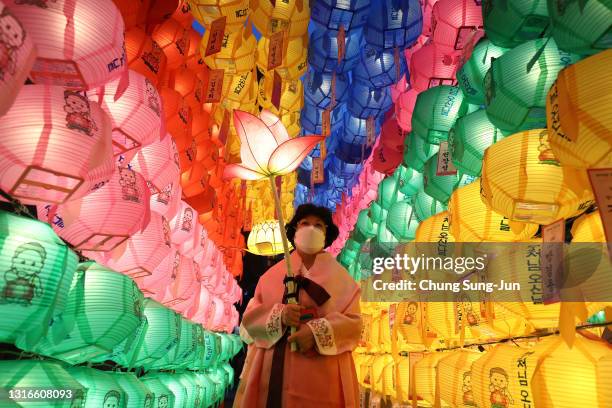 Buddhists gather under colorful lanterns as they celebrate the forthcoming birthday of Buddha at Jogyesa Temple on May 06, 2021 in Seoul, South...