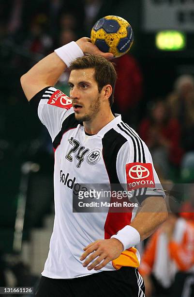 Michael Haass of Germany throws the ball during the Mens' Handball Supercup match between Germany and Spain at Gerry Weber stadium on November 6,...