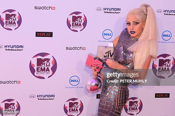 Pop star Lady Gaga poses with her four awards for Best Video, Best Song, Best Female and Biggest Fans, at the MTV European Music Awards at the...