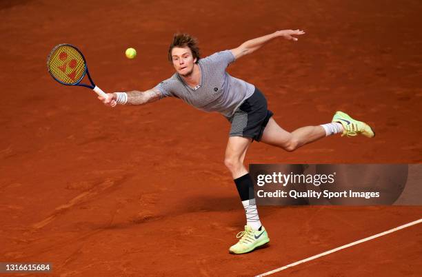 Alexander Bublik of Kazakhstan returns a shot in his round of 16 match against Aslan Karatsev of Russia on day eight of the Mutua Madrid Open tennis...