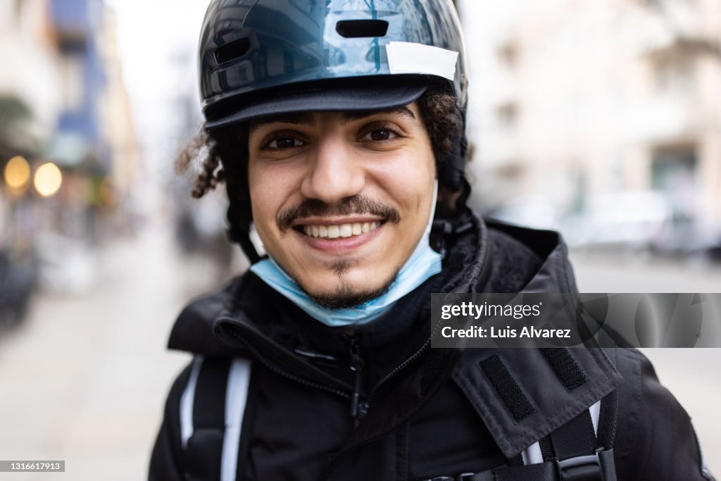 Close-up of a male courier person in the city
