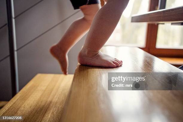 toddler walking up on staircase - baby climbing stock pictures, royalty-free photos & images