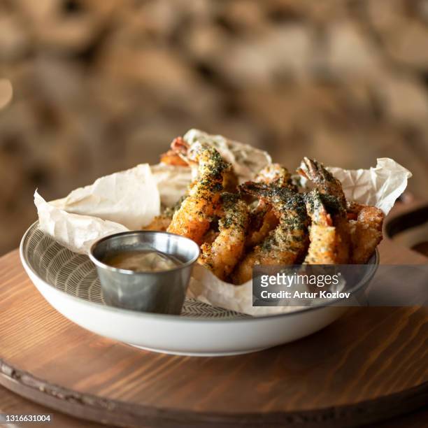 fried king prawn or shrimp platter with sauce on blurred background. seafood concept. spicy oriental dish, pan-asian cuisine - king fries stock pictures, royalty-free photos & images