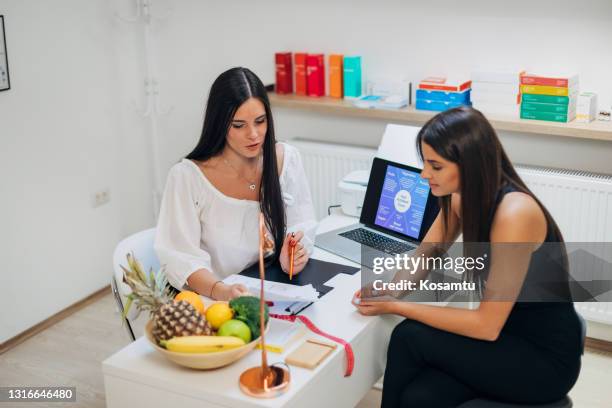 nutritionist discuss the test result about food allergy with her client, while making her nutrition and treatment plan - high fibre diet stock pictures, royalty-free photos & images