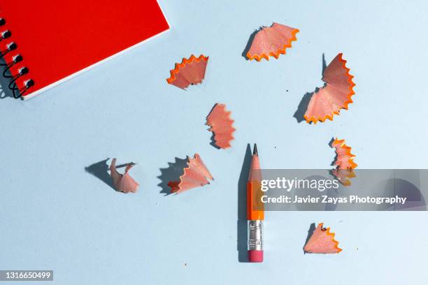 used worn orange pencil with eraser on blue background - pencil with rubber stock pictures, royalty-free photos & images