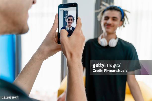 young teenage boys vlogging - filming stock pictures, royalty-free photos & images
