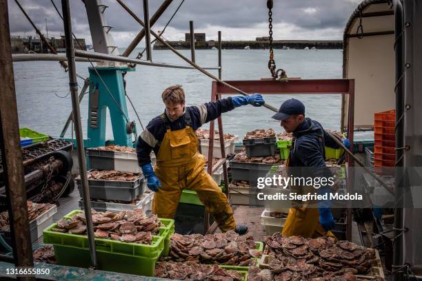 French fishermen unload the day's catch from their boat on May 6, 2021 to store in the fishery harbour of Granville, France. French fishery...