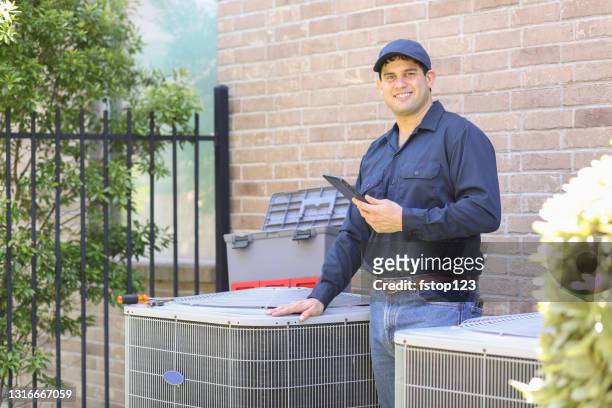 latin descent, blue collar air conditioner repairman at work. - repairing stock pictures, royalty-free photos & images