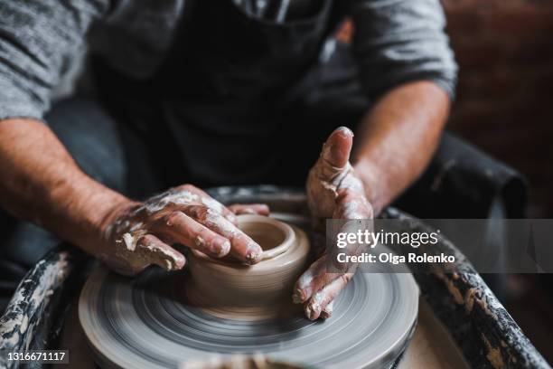 close up male hands make a pot of clay in a pottery workshop - potter stock pictures, royalty-free photos & images