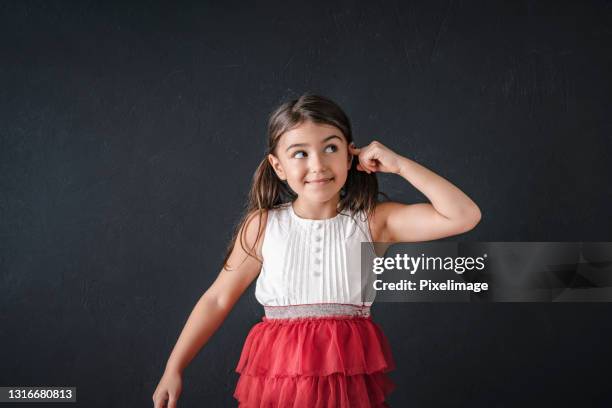 portrait of a child schoolgirl with imagination at the blackboard - kids background stock pictures, royalty-free photos & images