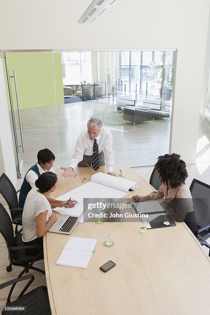 Project discussions amongst employees in boardroom