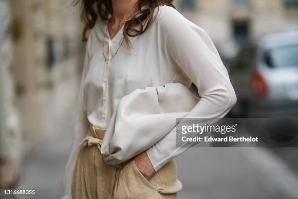 Ketevan Giorgadze @katie.one wears beige linen and silk blend trousers, high-waisted with side pockets, pleats at the front and a belt from Cortana,...