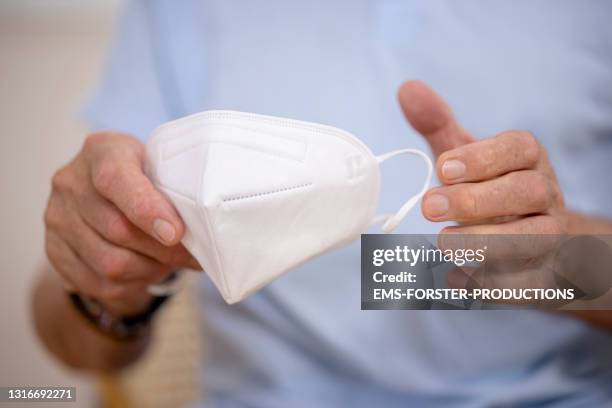 close up of a protective ffp2 mask in the doctor's office during the coronavirus epidemic - masks fotografías e imágenes de stock