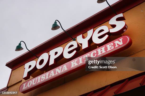 Sign hangs outside of a Popeyes Louisiana Kitchen restaurant on May 06, 2021 in Chicago, Illinois. Chicken prices have risen sharply this year as...