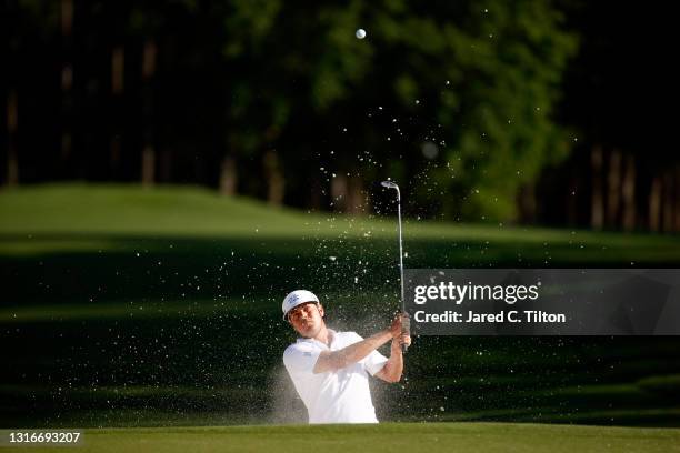 Keith Mitchell of the United States plays a shot from a bunker on the ninth hole during the first round of the 2021 Wells Fargo Championship at Quail...