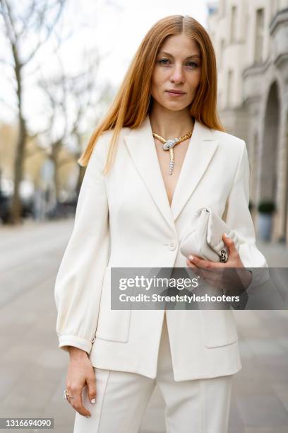 Influencer Lisa Banholzer wearing a white suit by Dorothee Schumacher, a white bag by Bvlgari, a yellow and white gold snake ring with diamond and...