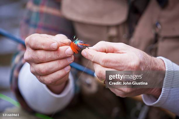 usa, washington, vancouver, close-up of fisherman's hands tying fly onto line - tackle stockfoto's en -beelden