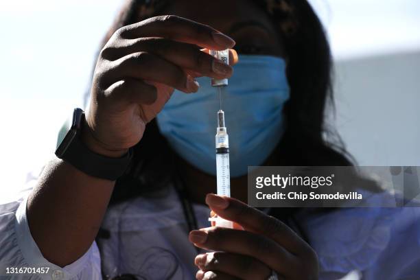 Health Nurse Manager Ashley Hennigan fills a syringe with a dose of the Johnson & Johnson coronavirus vaccine during a walk-up clinic at the John F....