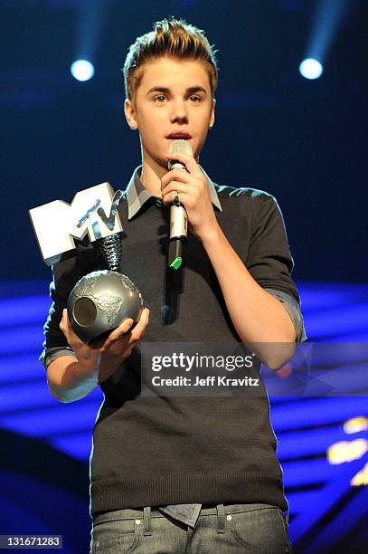 Justin Bieber accepts an award onstage during the MTV Europe Music Awards 2011 live show at the Odyssey Arena on November 6, 2011 in Belfast,...