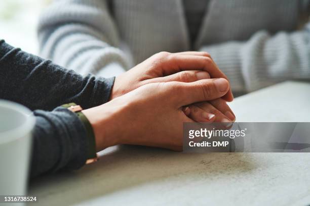cropped shot of an unrecognizable nurse sitting with her senior patient at home and holding her hand - emotional support stock pictures, royalty-free photos & images