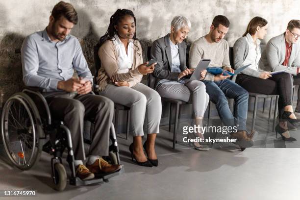 business people anticipating job interview in waiting room. - job candidate stock pictures, royalty-free photos & images