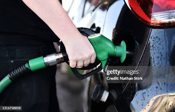 Man fills a car with Unleaded Petrol at Asda petrol station on May 07, 2021 in Stoke-on-Trent, England. The Asda owners are set for a £6.8bn buyout...