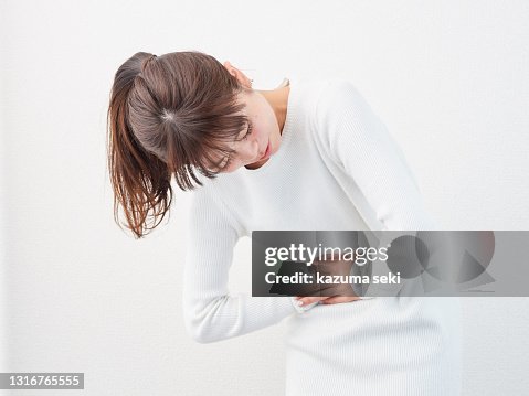 Asian woman with a stomachache Asian woman with a stomachache