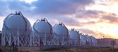 Gas storage tanks at sunset.